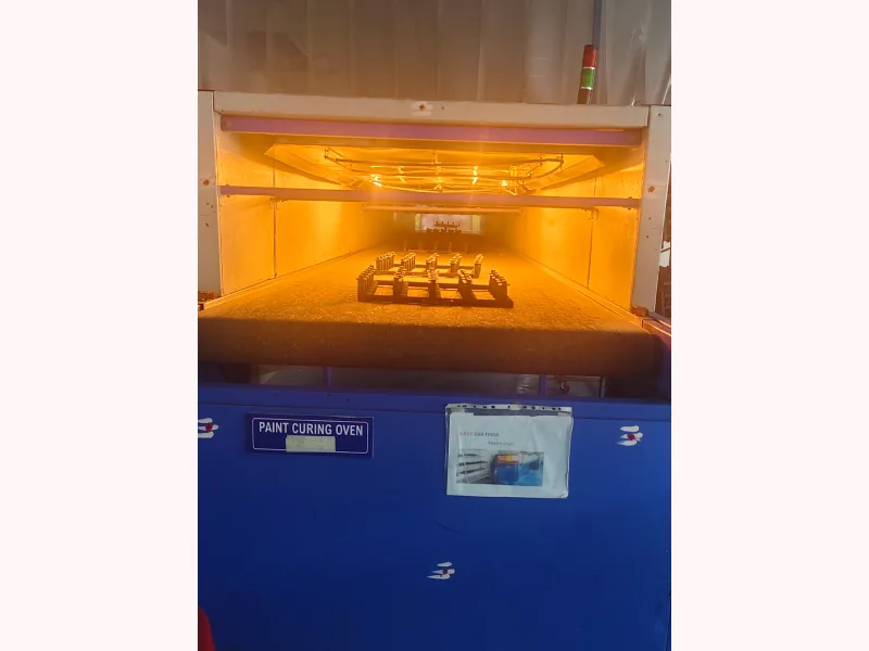 Paint curing oven signage inside the Aaru Plastics spray painting unit